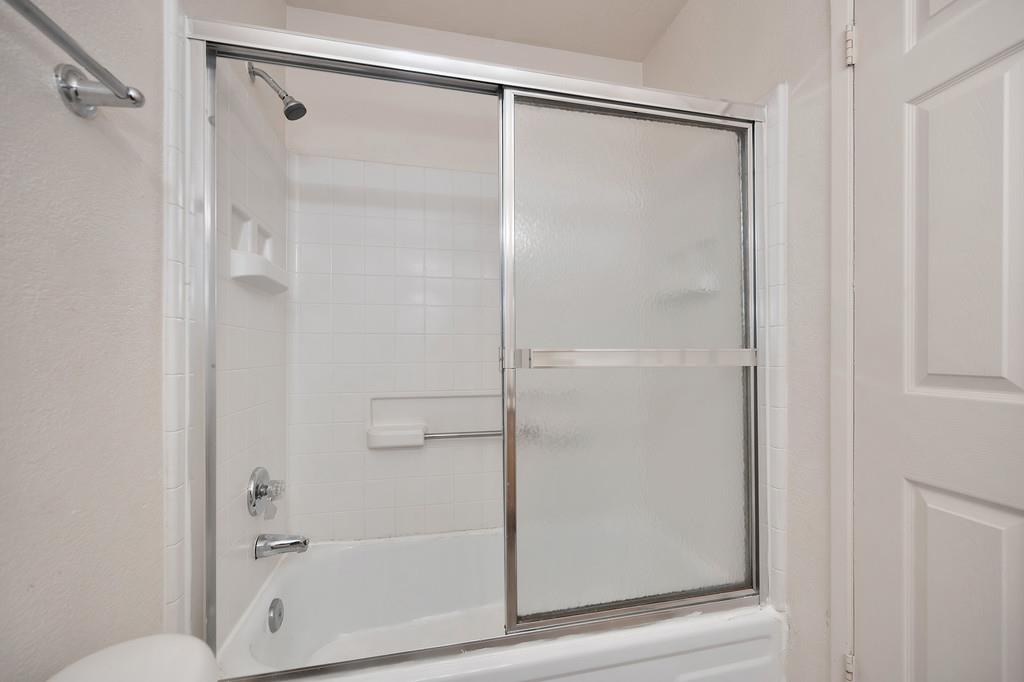 9160 Madison Avenue, Unit 57 Fair Oaks, CA 95628 - Photo 25 of 40 a bathroom with a glass shower door