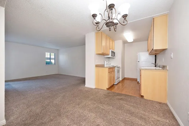 a view of a kitchen with a sink cabinets and a ceiling fan
