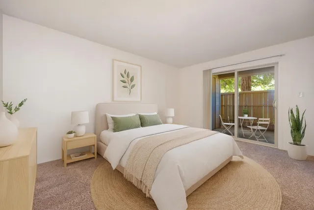 a bedroom with a bed and a large window