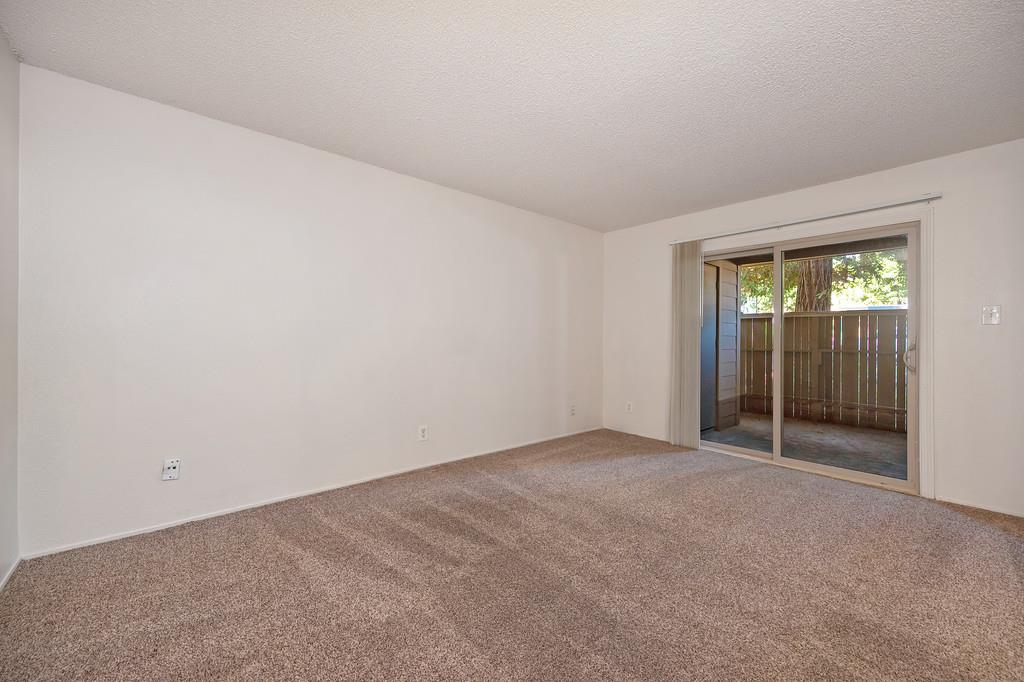 9160 Madison Avenue, Unit 57 Fair Oaks, CA 95628 - Photo 10 of 40 an empty room with sliding door