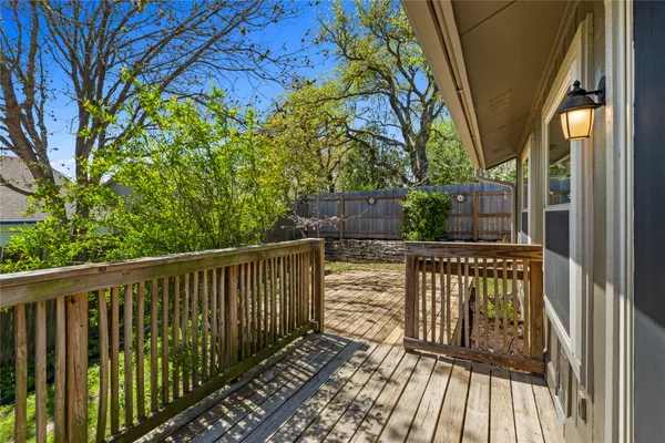 a view of balcony with wooden floor and fence