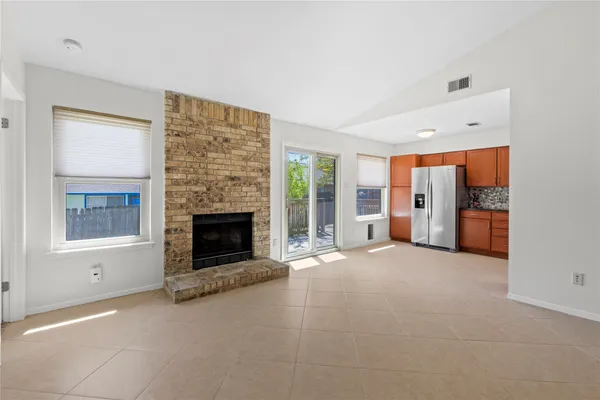 a view of a livingroom with an empty space and a fireplace