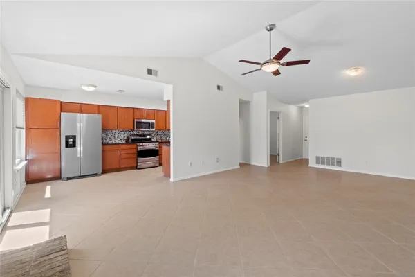 a view of a kitchen with a sink and refrigerator