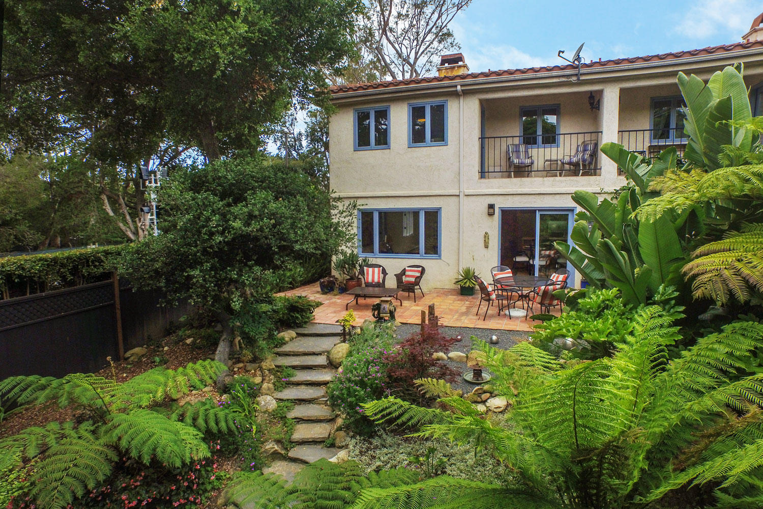 a view of a house with pool and sitting area