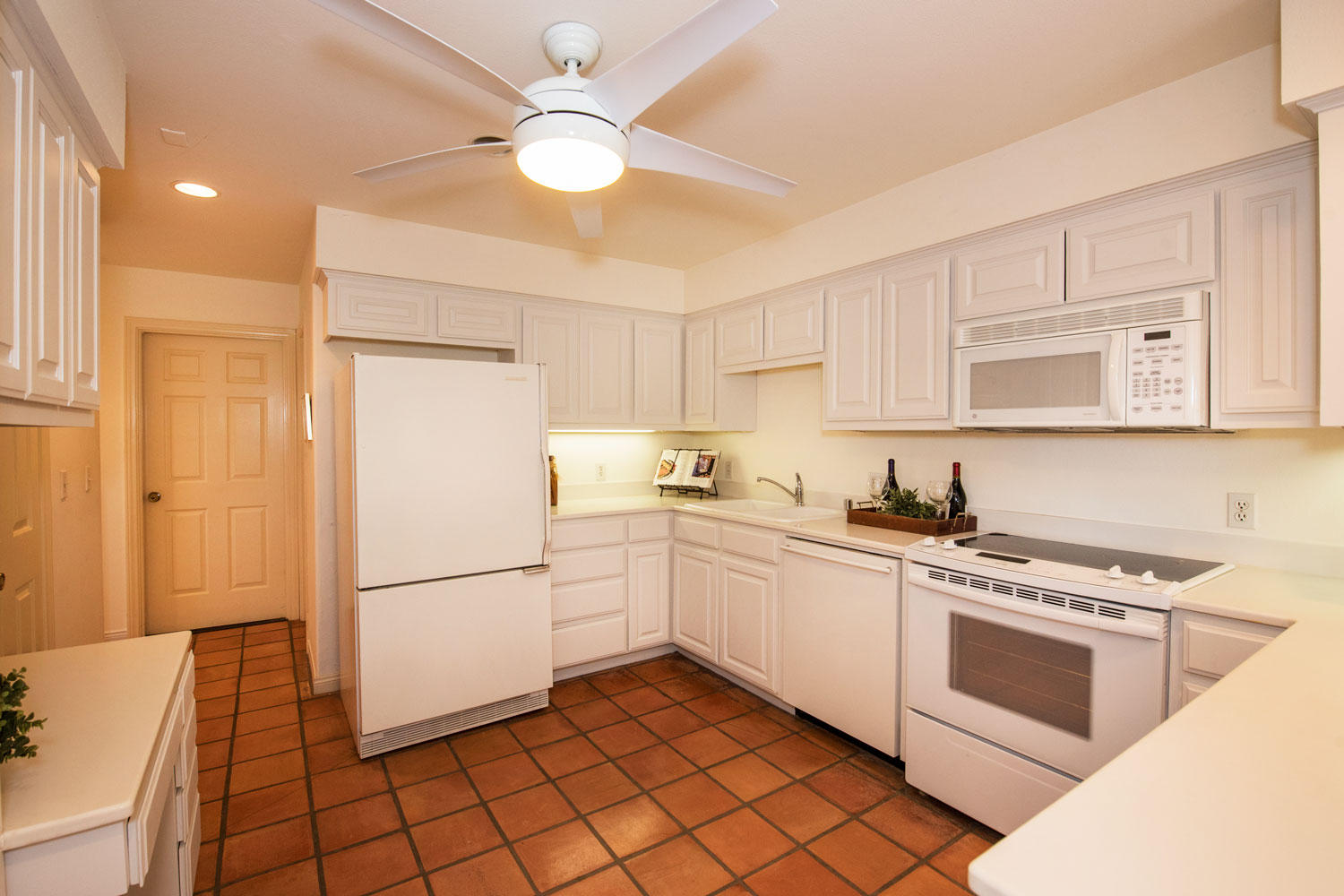 62 Olive Mill Road Santa Barbara, CA 93108 - Photo 8 of 23 a kitchen with white cabinets and white appliances