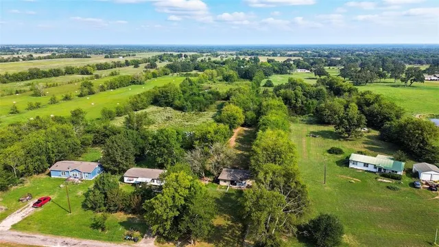 a view of a city with lush green forest