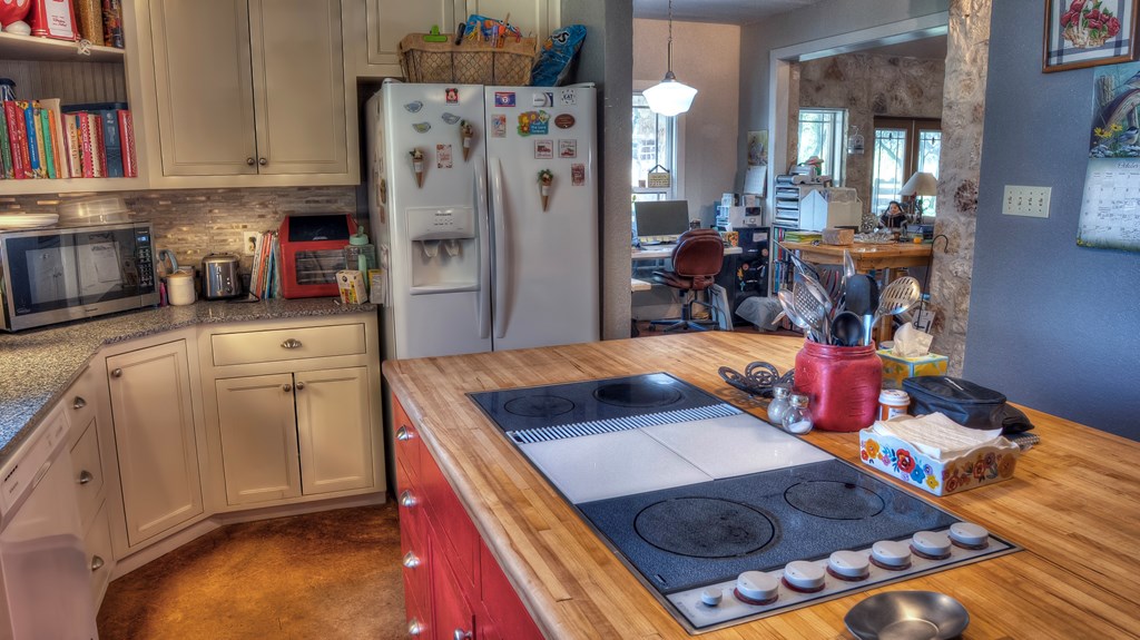 4573 Ranch Road 1120 Rio Frio, TX 78879 - Photo 16 of 71 a kitchen with stainless steel appliances granite countertop a refrigerator and a stove