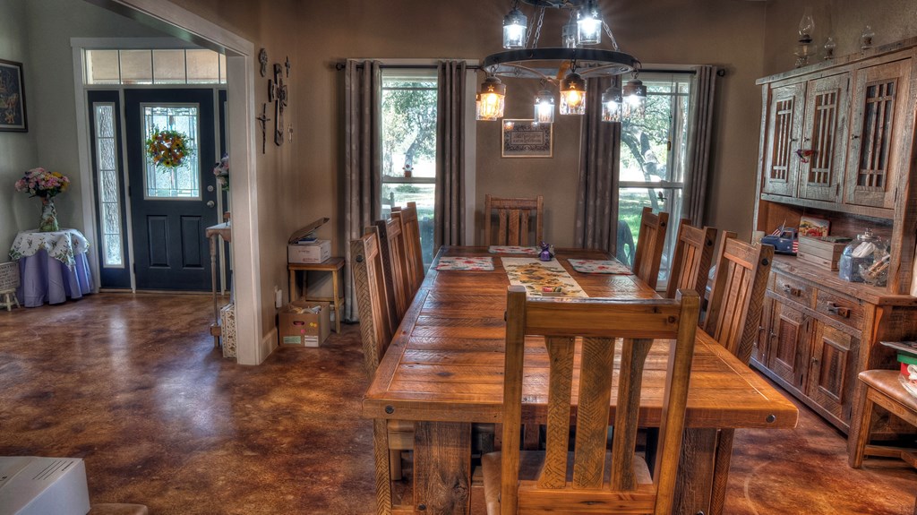 4573 Ranch Road 1120 Rio Frio, TX 78879 - Photo 21 of 71 a dining room with wooden floor and stairs