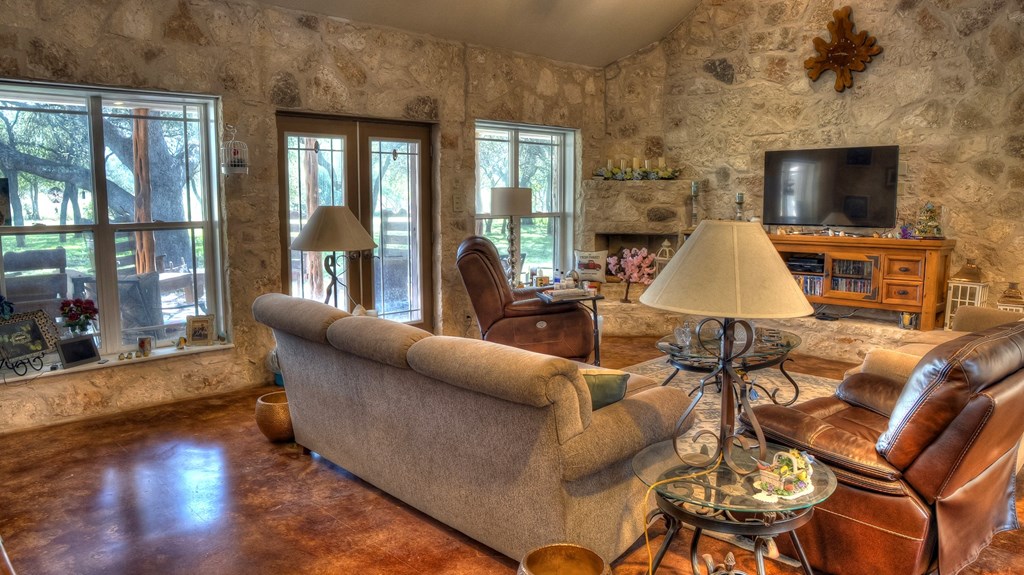 4573 Ranch Road 1120 Rio Frio, TX 78879 - Photo 25 of 71 a living room with furniture and a fireplace