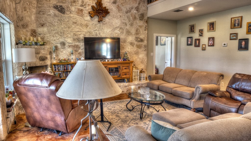 4573 Ranch Road 1120 Rio Frio, TX 78879 - Photo 26 of 71 a living room with furniture and a fireplace