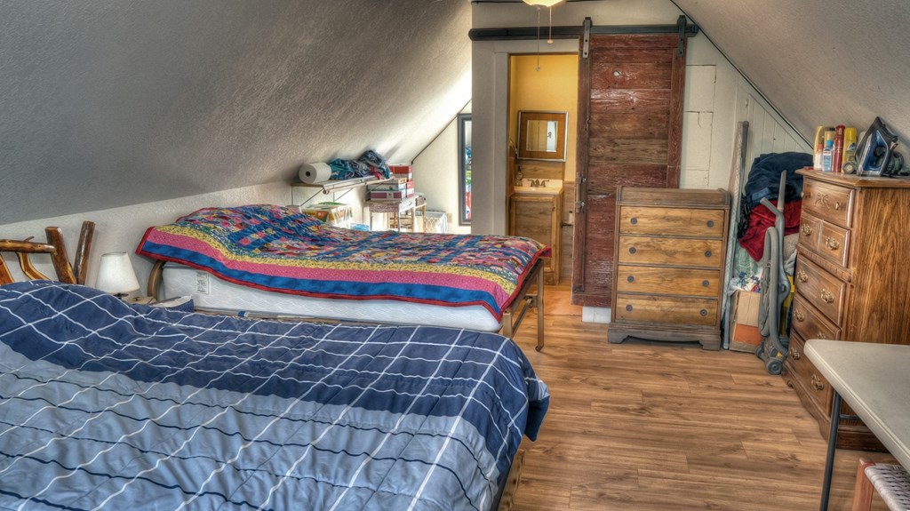 4573 Ranch Road 1120 Rio Frio, TX 78879 - Photo 42 of 71 a bedroom with a bed and wooden floor