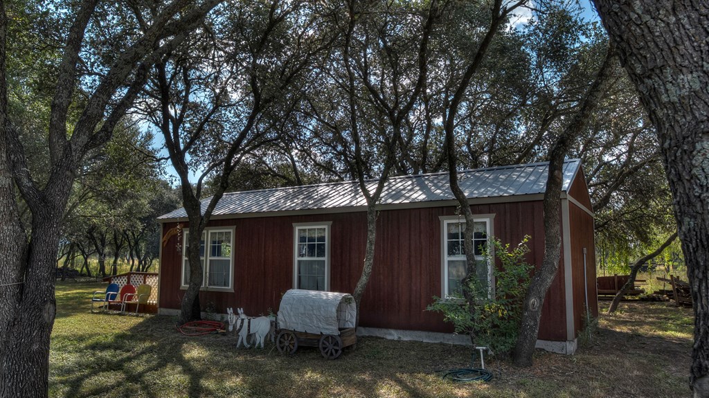 4573 Ranch Road 1120 Rio Frio, TX 78879 - Photo 48 of 71 a view of a house with backyard and trees in the background
