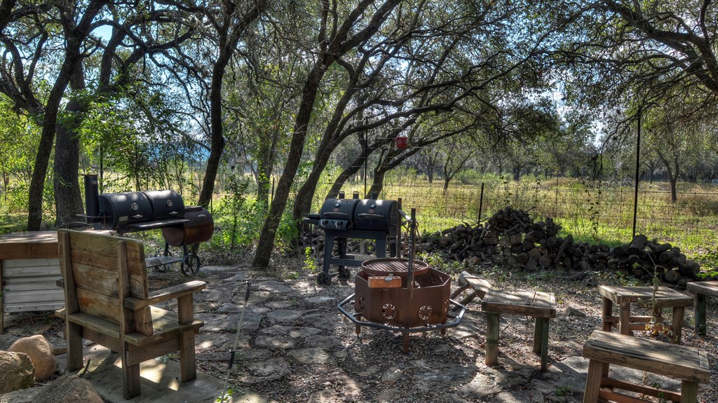4573 Ranch Road 1120 Rio Frio, TX 78879 - Photo 53 of 71 a view of a garden with plants and a bench