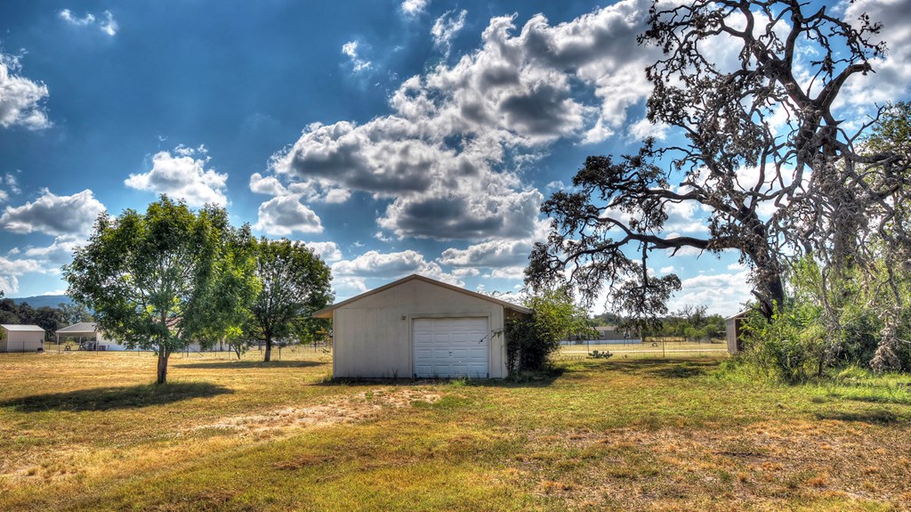 4573 Ranch Road 1120 Rio Frio, TX 78879 - Photo 56 of 70 a yellow house with trees in front of it