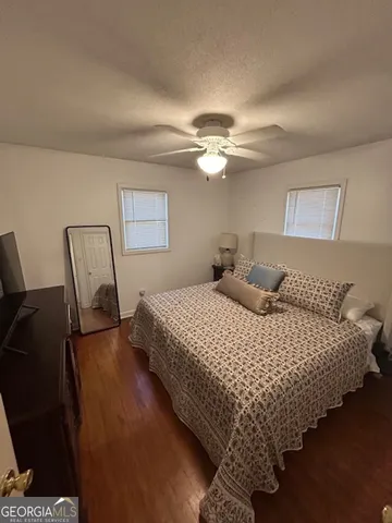 a bedroom with bed and window