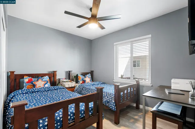 a bedroom with two beds and painted walls