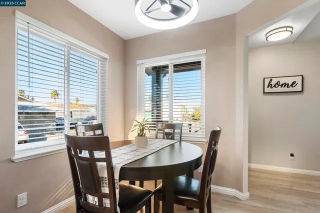 a view of a dining room with furniture and window