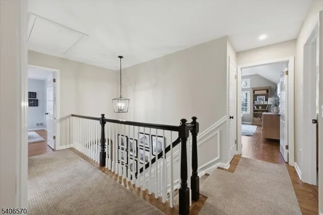 a view of a hallway with a livingroom and furniture
