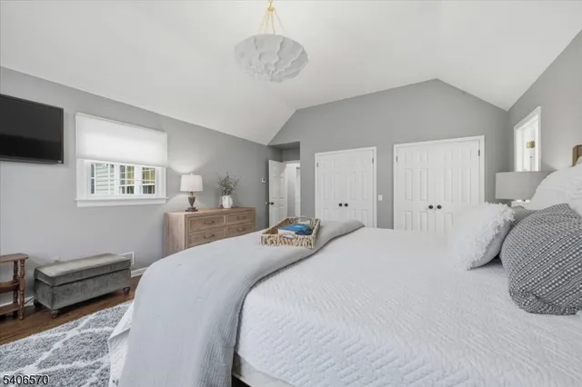 a bedroom with a large bed and a tv