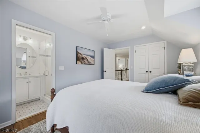 a bedroom with a bed and a painting on the wall