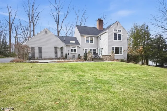 a front view of a house with a yard and trees