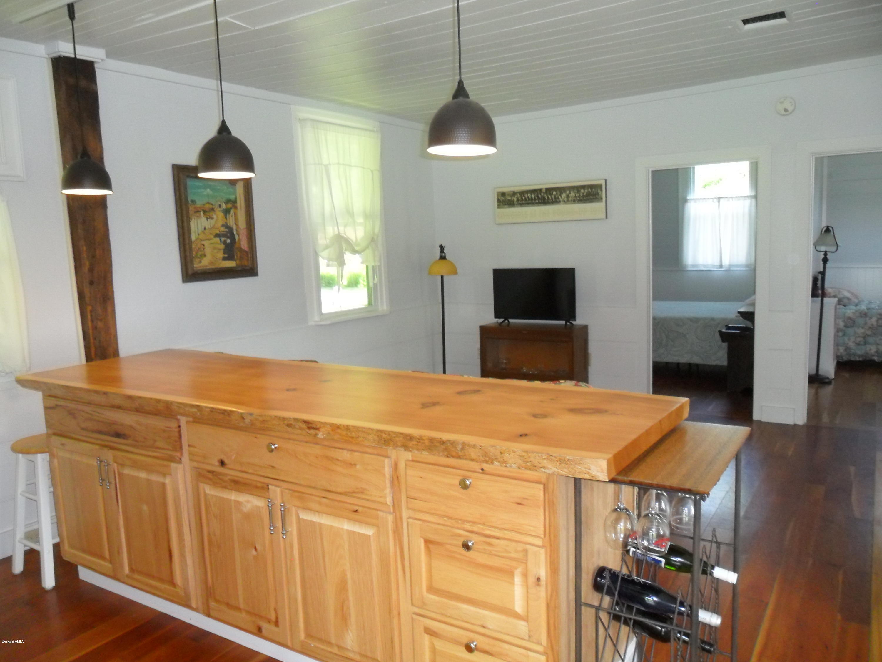 107 State Line Road West Stockbridge, MA 01266 - Photo 22 of 52 a kitchen with stainless steel appliances granite countertop a stove and a wooden floor