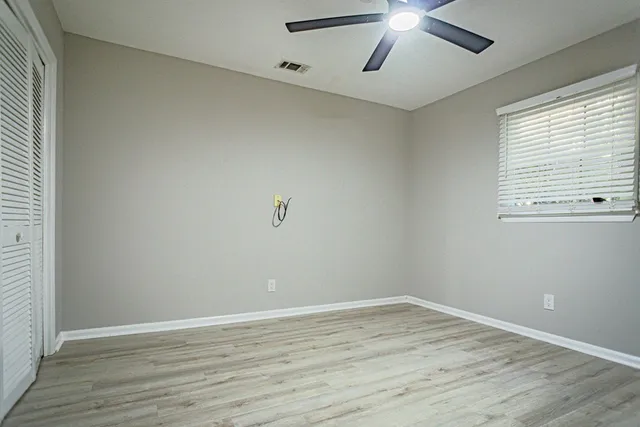 wooden floor in an empty room with a window
