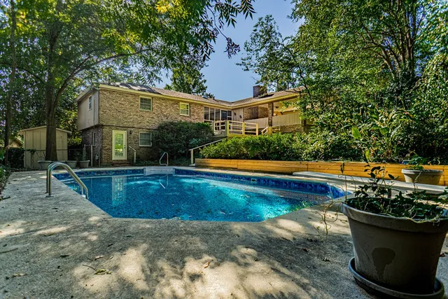 a view of a house with swimming pool and yard