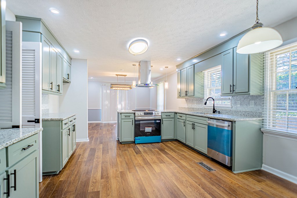 6221 Charing Drive Columbus, GA 31909 - Photo 4 of 18 a kitchen with stainless steel appliances granite countertop wooden floors and sink