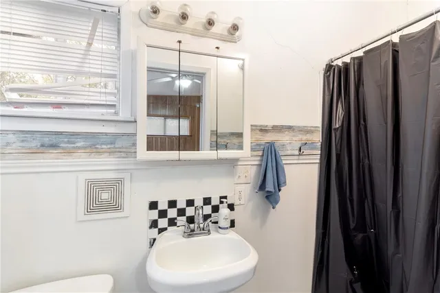 a bathroom with a sink toilet and shower