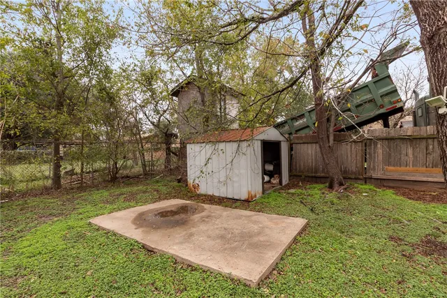 a view of a backyard with large tree