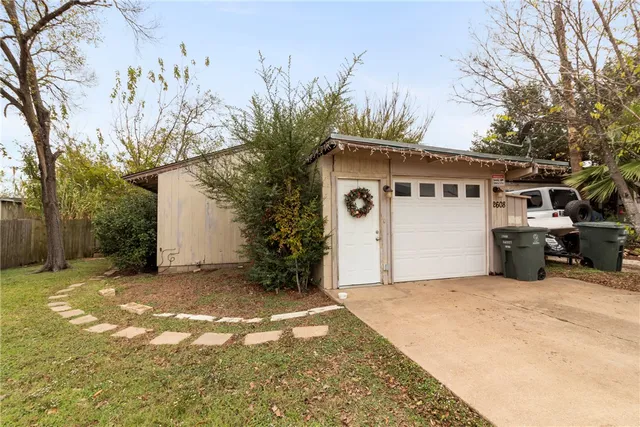 a view of a house with a yard covered with snow in the background