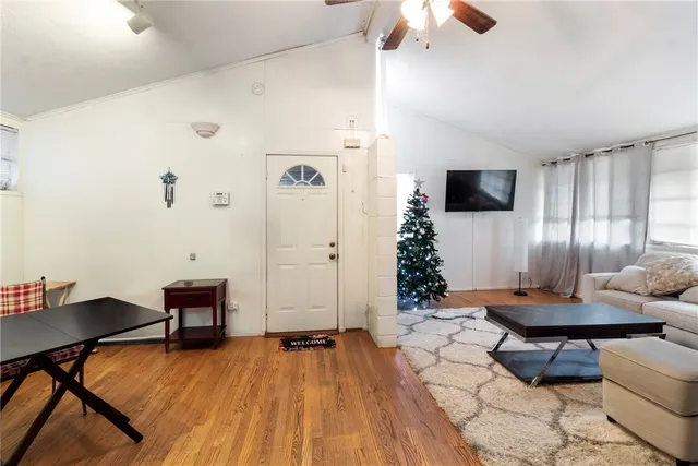 a living room with furniture and a wooden floor