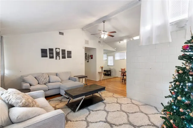 a living room with furniture and a potted plant