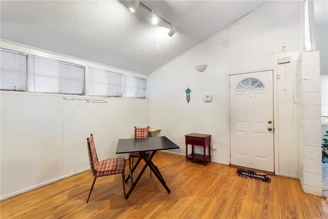 a view of a workspace with furniture and wooden floor