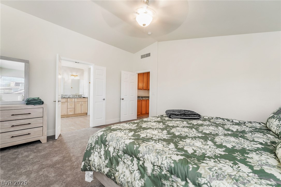 104 Appian Way Henderson, NV 89002 - Photo 16 of 24 A well-appointed bedroom suite offers direct access to a spacious private bathroom.
