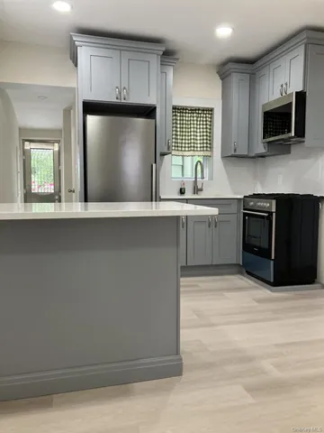 a kitchen with a refrigerator and a sink