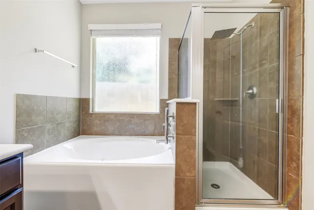 a bathroom with a bathtub and a shower