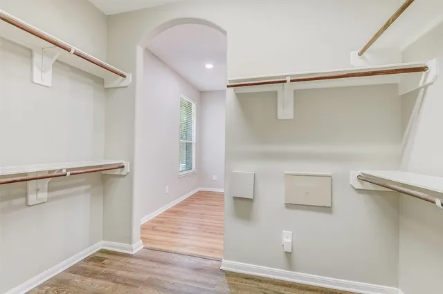 a view of walk in closet with empty racks