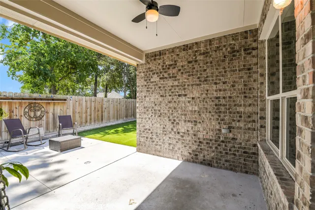 a view of a patio with a table and chairs and wooden floor
