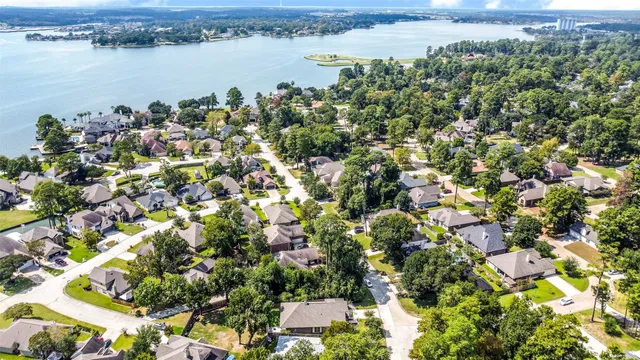 an aerial view of a houses with a lake view