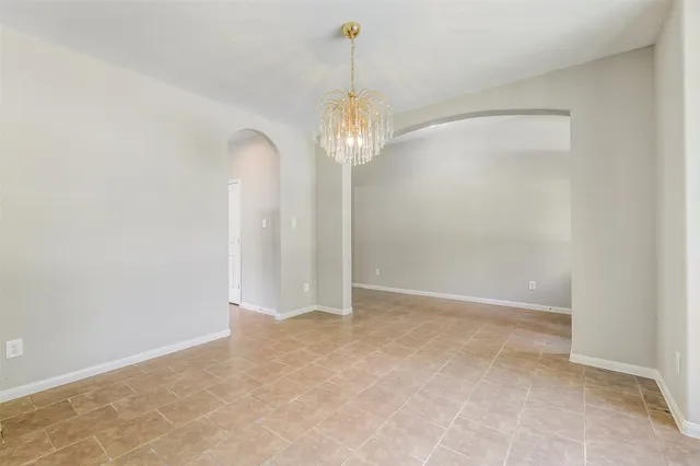 a view of a chandelier in big room and chandelier fan