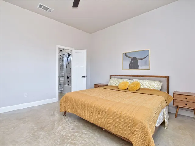 a bedroom with a bed and a night stand