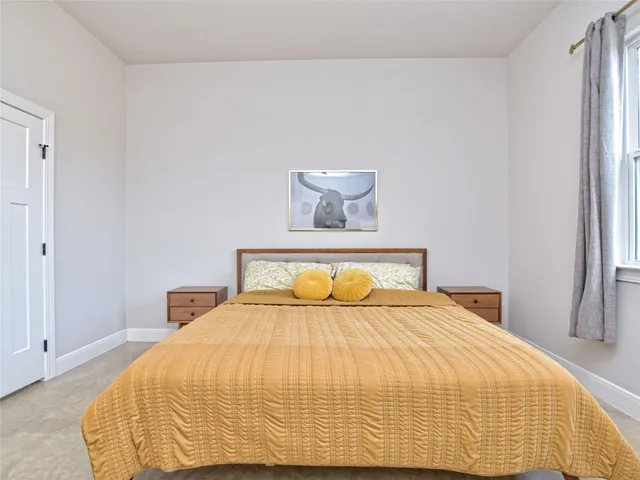 a bedroom with a bed and a window