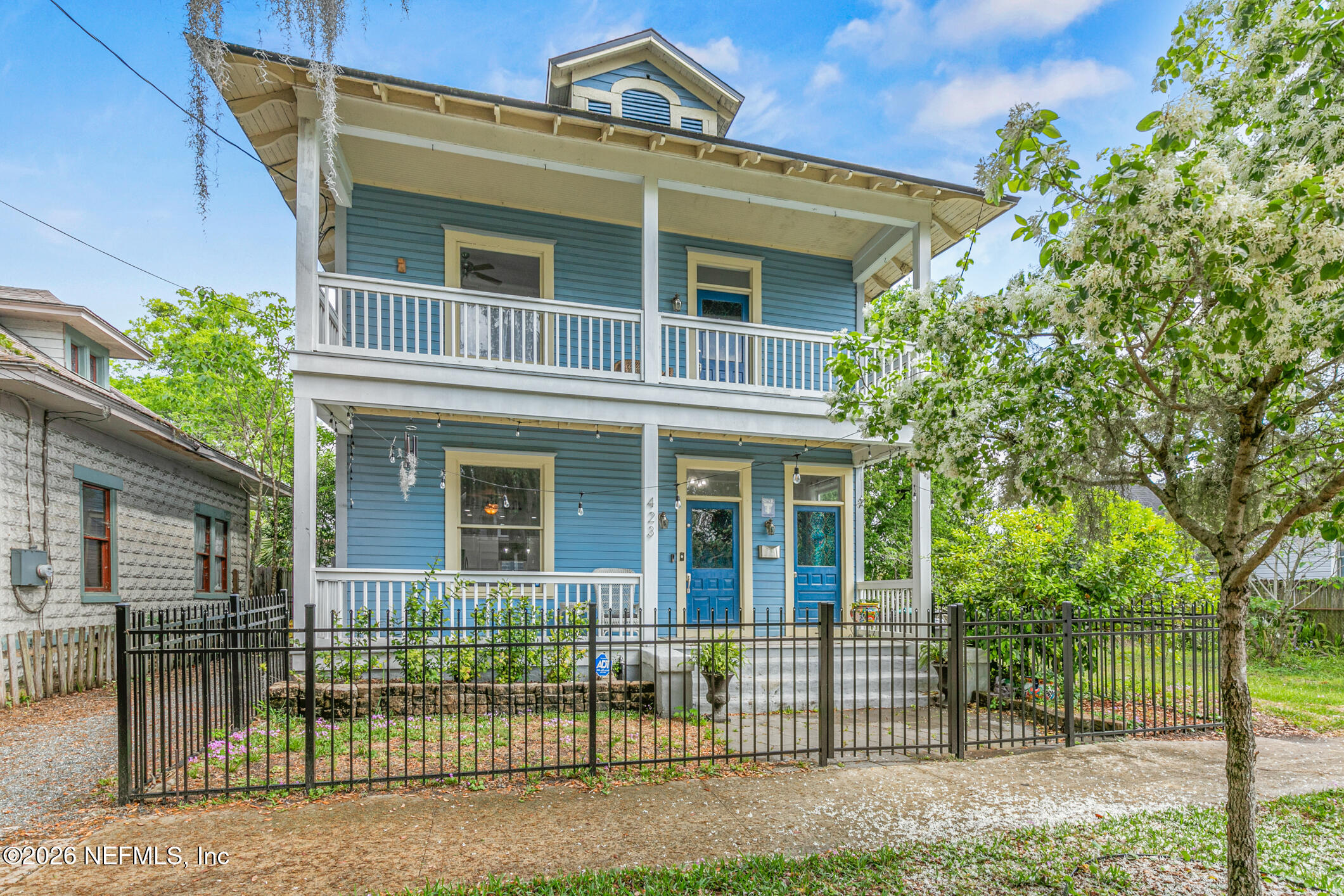 a view of a house with a iron gate