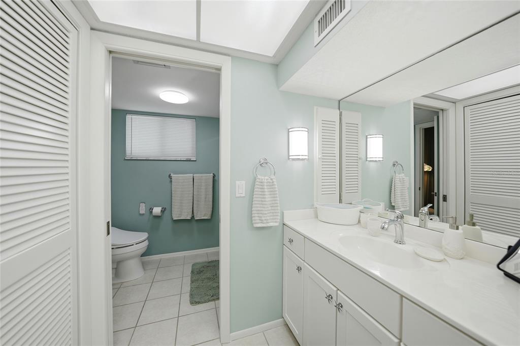 1 Colony Point Drive, Unit A10 Punta Gorda, FL 33950 - Photo 24 of 31 a bathroom with a double vanity sink toilet and a mirror
