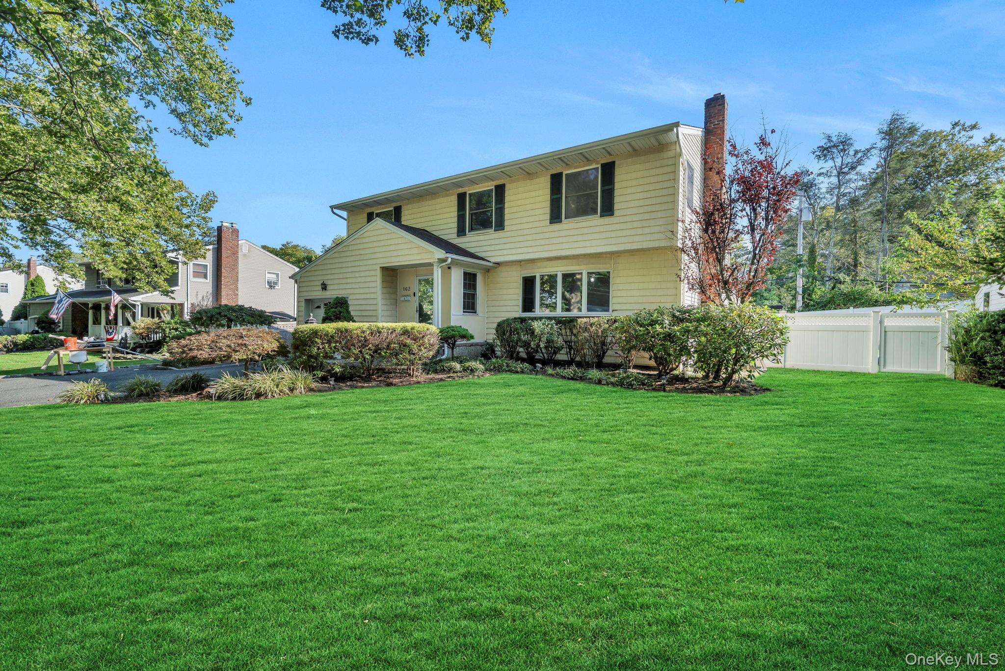 a front view of house with yard and green space