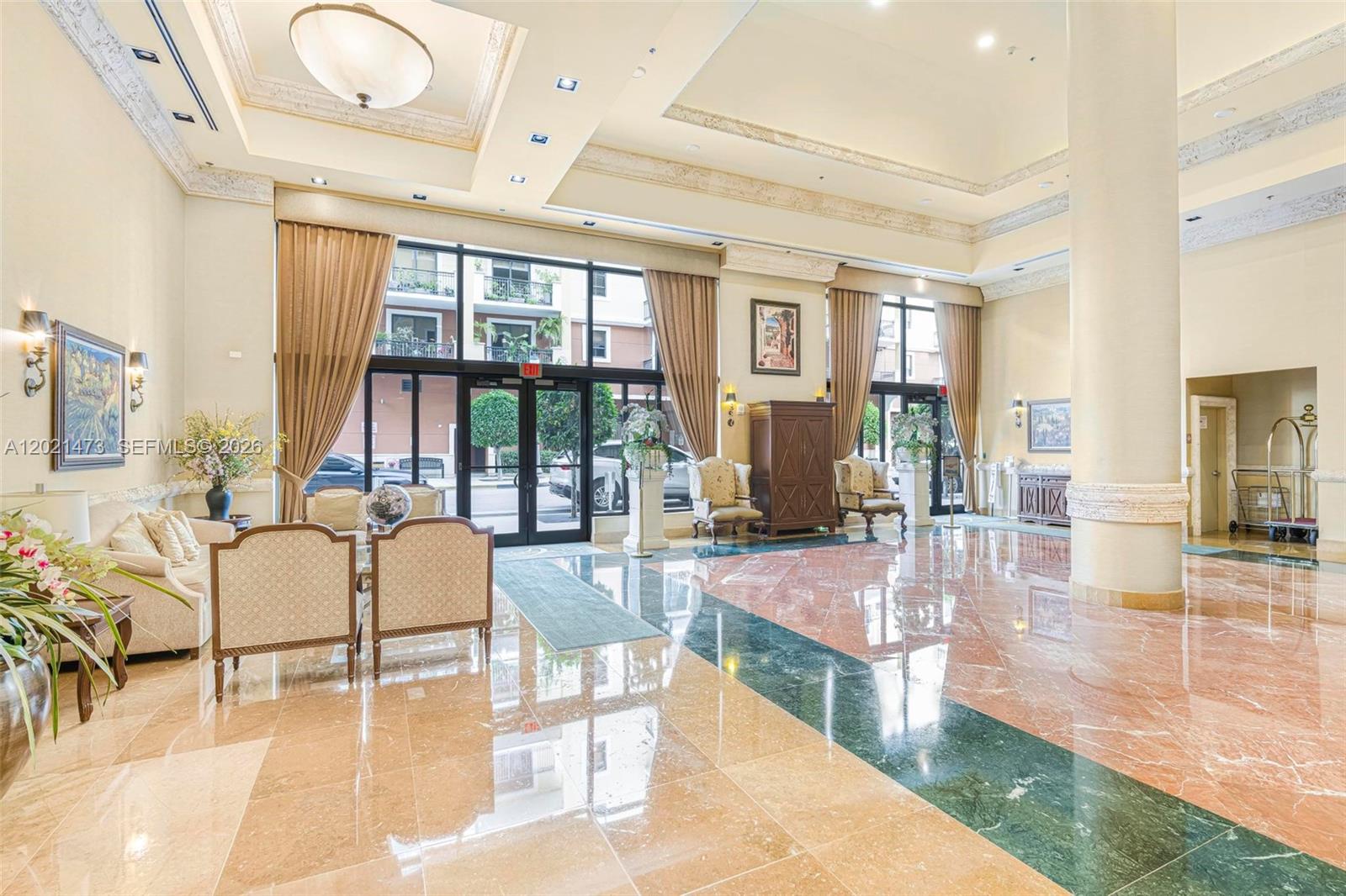 8395 Southwest 73rd Avenue, Unit 710 Miami, FL 33143 - Photo 4 of 32 a lobby with furniture and floor to ceiling windows