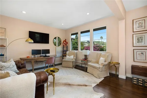 a living room with furniture a rug and a flat screen tv