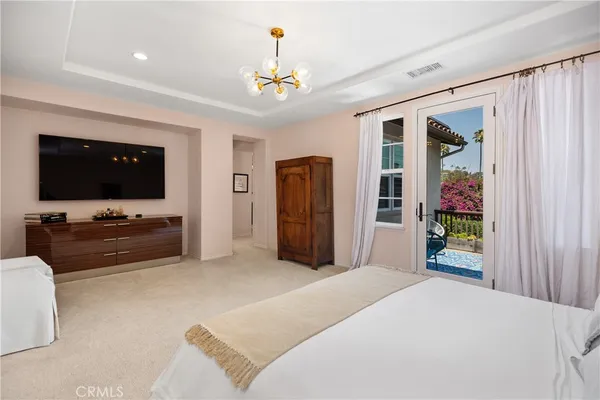 a bedroom with furniture and flat screen tv